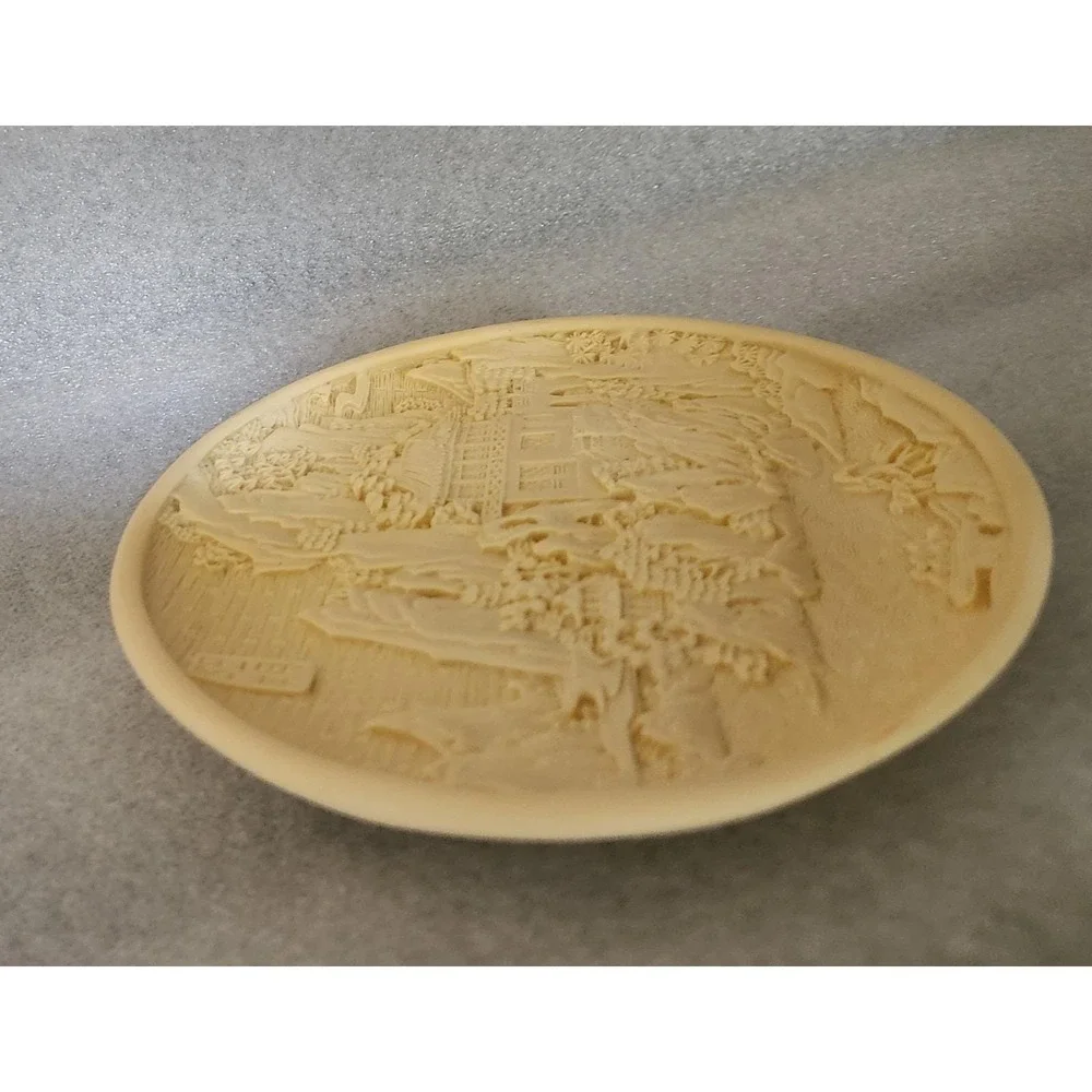 Vintage Chinese carved resin decorative plate with a landscape motif